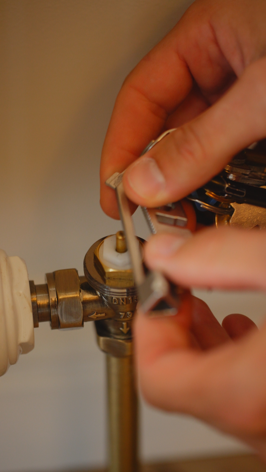Plumbing on demand close up of hands sorting through a tap